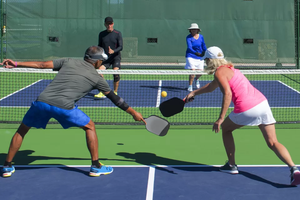 A mixed-doubles game of pickleball.